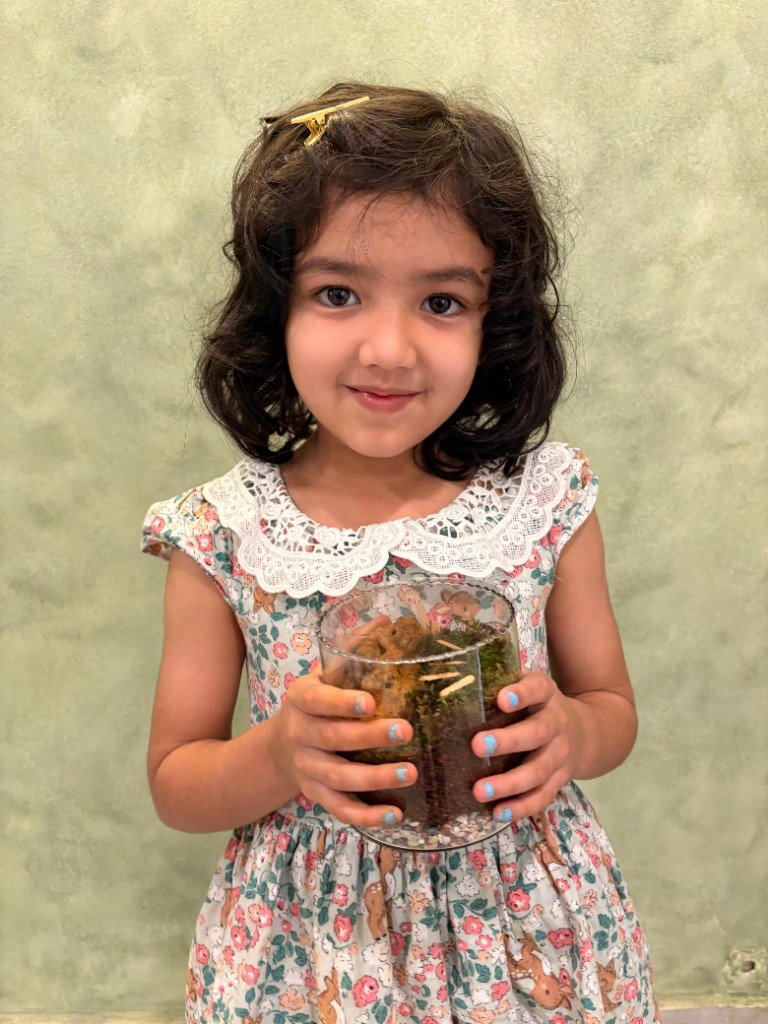 Close-up of child with completed terrarium